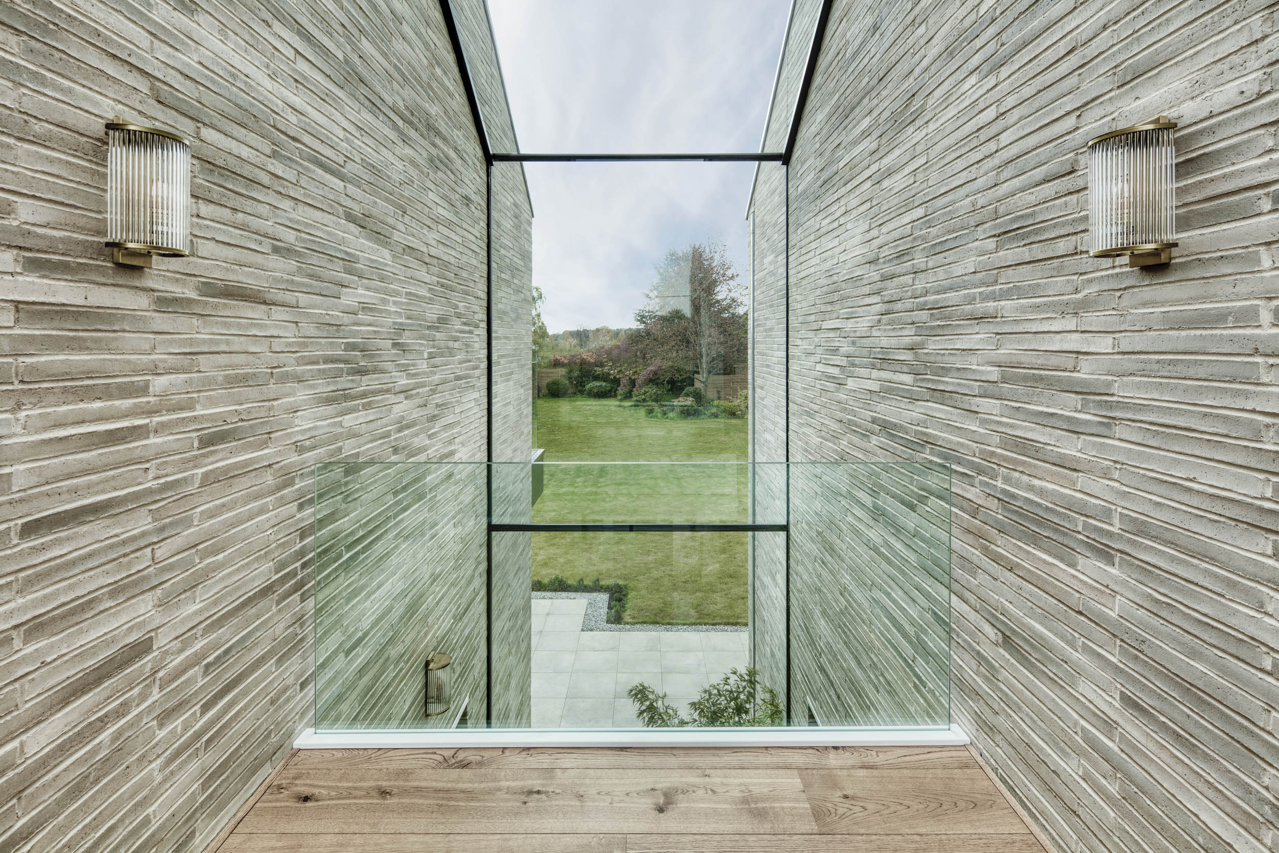 Minimally framed oversized glass link modern new build country home