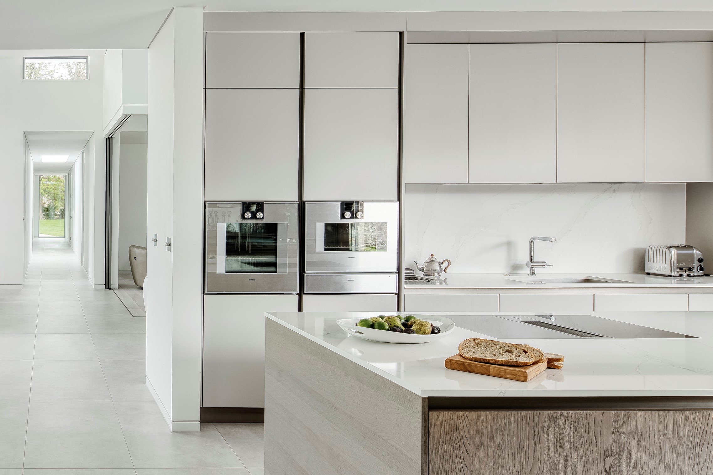 Open plan clean white lines minimal kitchen interior design