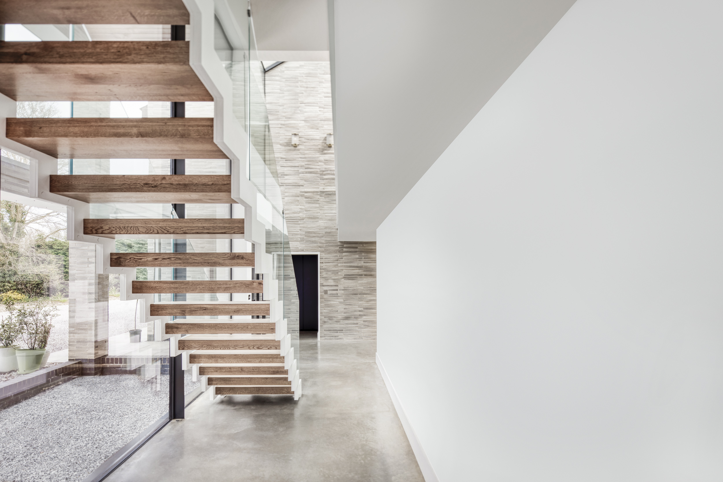 Dramatic floating glazed stair design luxury new build country home