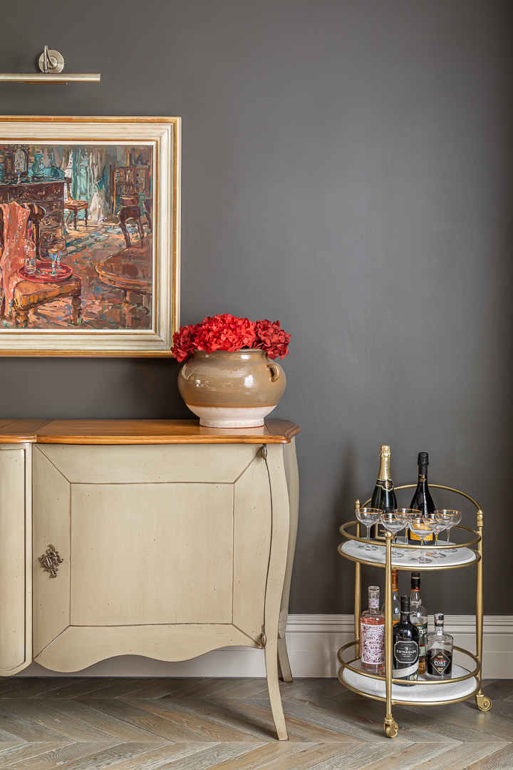 London chic interior design with matte grey walls and elegant sideboard
