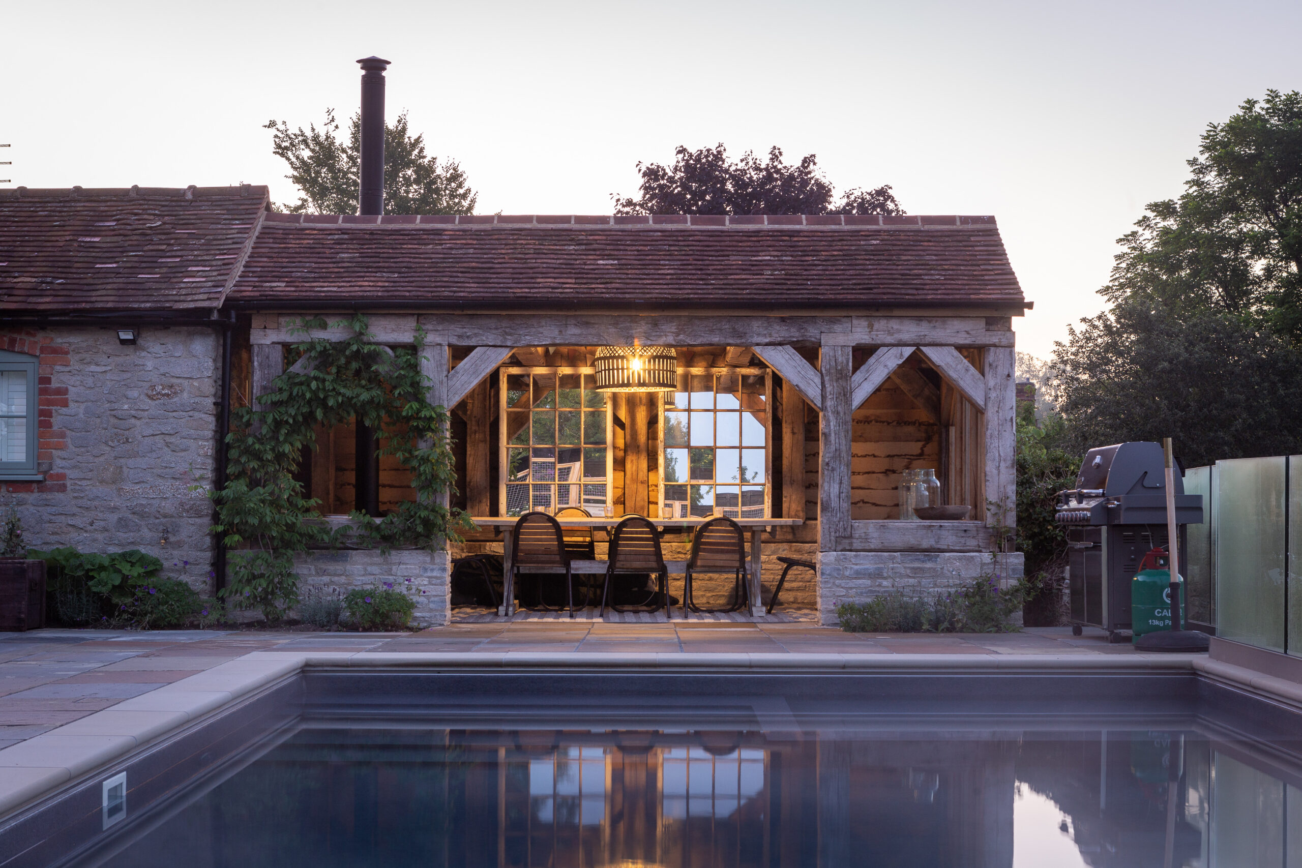 Sustainable restored oak poolside pavilion landscape design country home