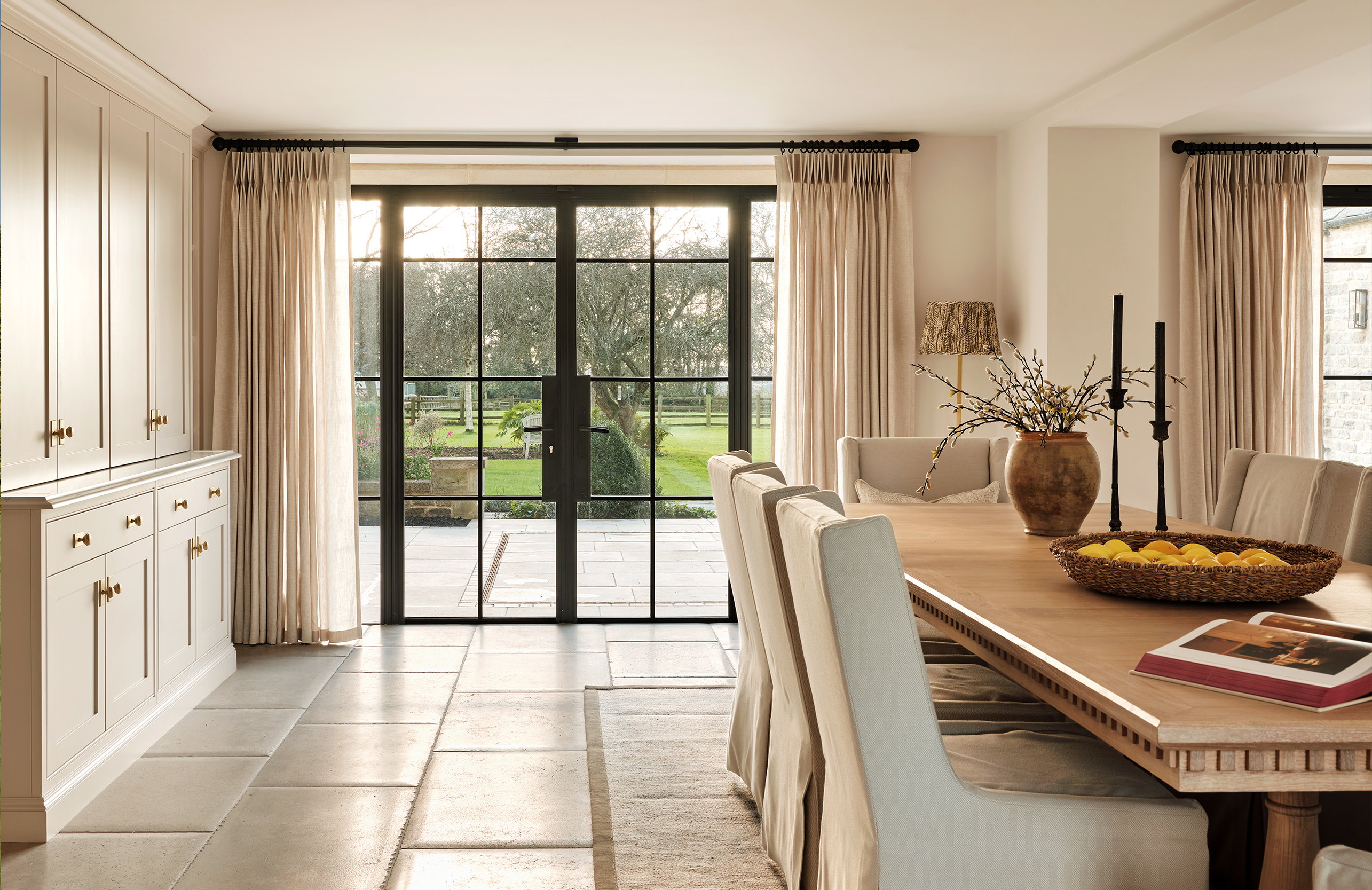 Large glass doors allow light to flood in and creates a connection with the outdoors