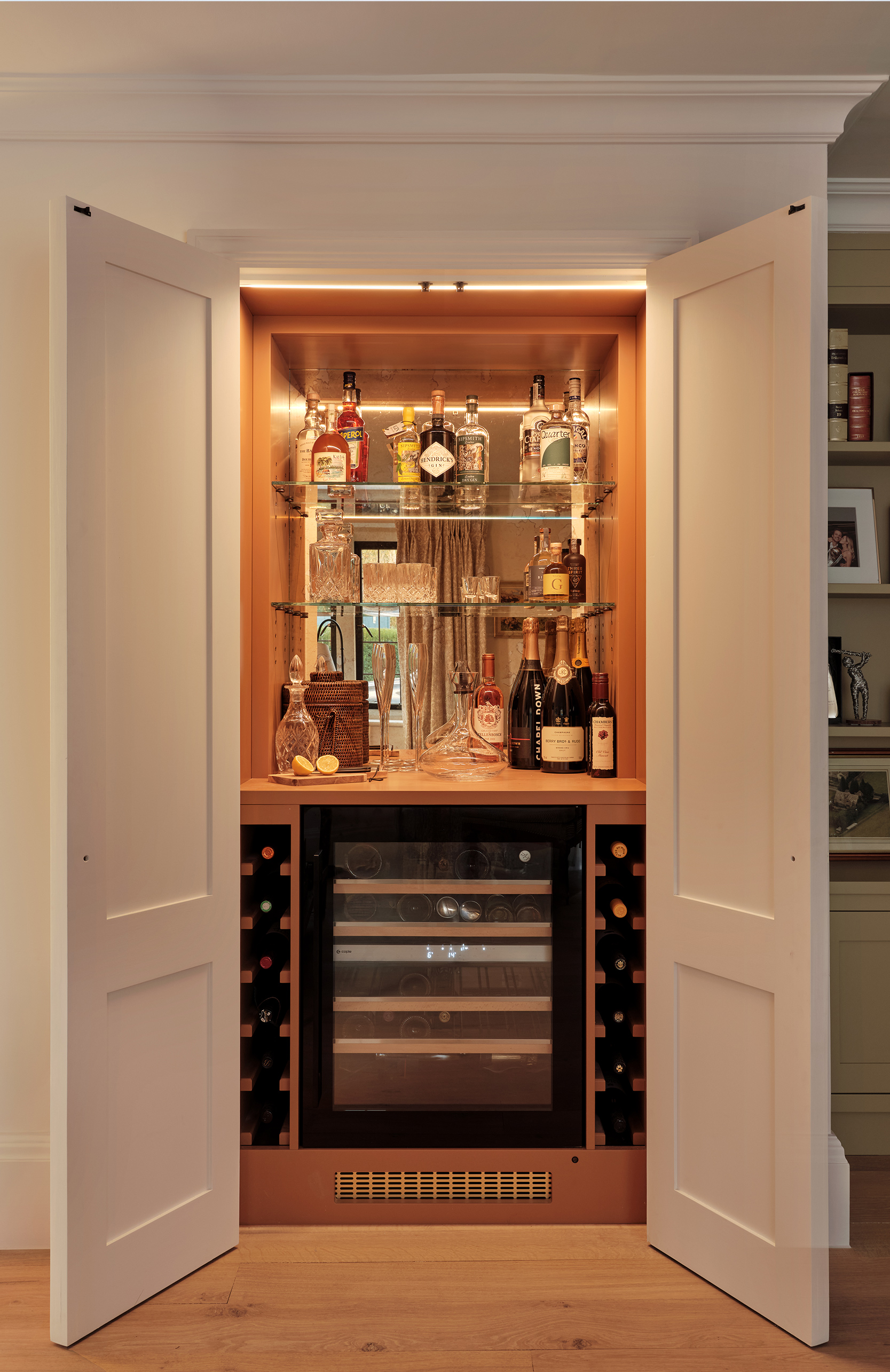 Bespoke joinery housing a hidden bar in the living room