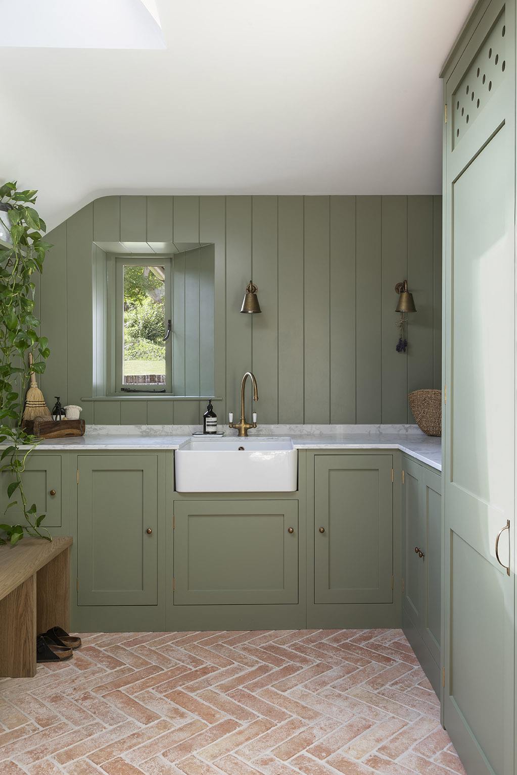 Green interiors in the boot room at Lark's Barn in Oxfordshire