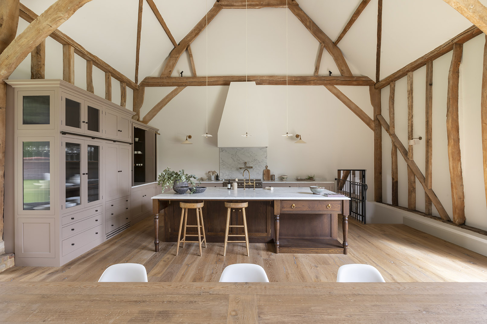 Barn restoration in Oxfordshire showing the kitchen interior design with exposed beams by HollandGreen